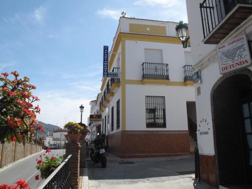 a building on the side of a street at Acantilados De Maro in Maro