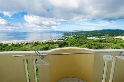 a balcony with a view of the ocean at Yomitan Ocean View Apartment 403 in Yomitan