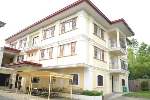 a white building with a lot of windows at Metro Vigan Inn in Vigan