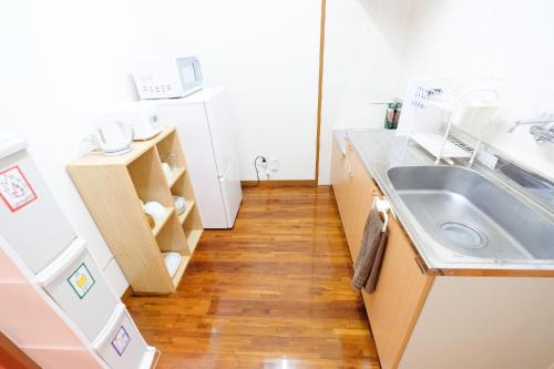 Kuchyň nebo kuchyňský kout v ubytování Yomitan Ocean View Apartment 402