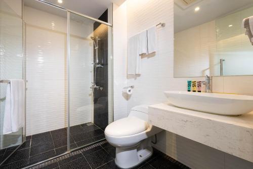 高雄的住宿－華園大飯店草衙館，一间带水槽、卫生间和淋浴的浴室