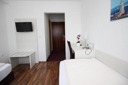 Ένα ή περισσότερα κρεβάτια σε δωμάτιο στο Hotel Olympia