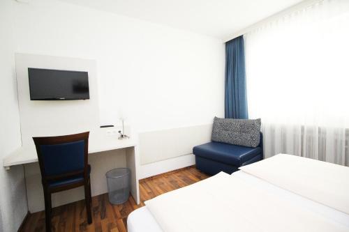 Ένα ή περισσότερα κρεβάτια σε δωμάτιο στο Hotel Olympia