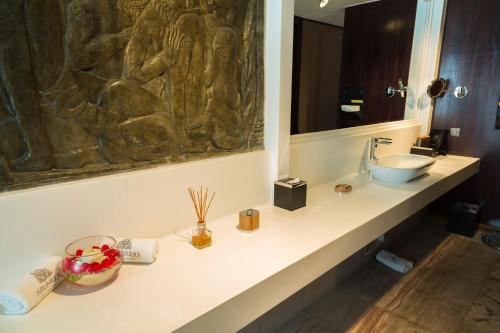 a bathroom with a sink and a mirror at Arunreas Hotel in Phnom Penh