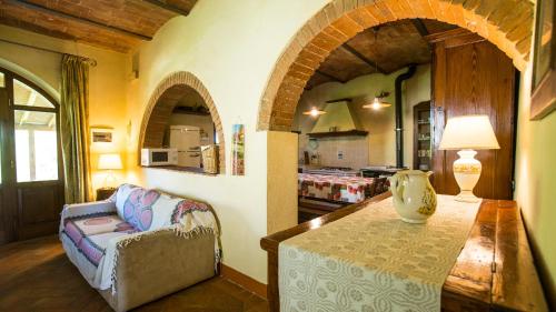 a living room with a couch and a table at La Stalla in Acquaviva