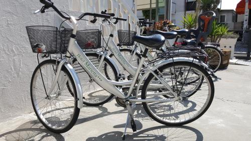 two bikes parked next to each other on a sidewalk at Hotel Marietta in Caorle