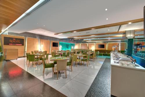 a dining room with tables and chairs in a restaurant at Al Khoory Executive Hotel, Al Wasl in Dubai