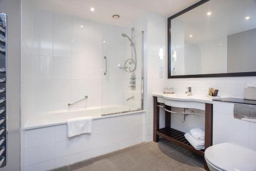 a bathroom with a tub and a sink and a shower at Ten Hill Place in Edinburgh