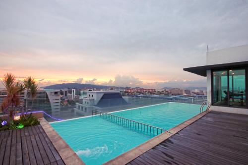 a swimming pool on the roof of a building at Cozy Living Sky Apartment in Kota Kinabalu