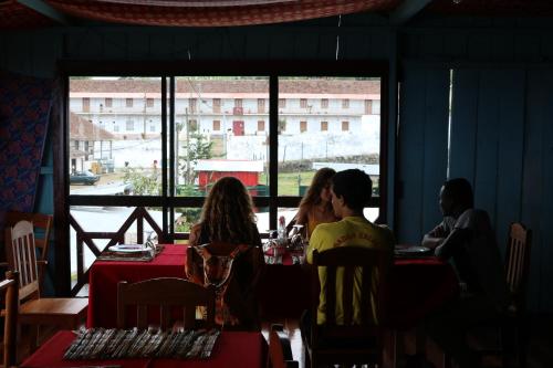 a group of people sitting at a table in a restaurant at Firma Efraim in Trindade