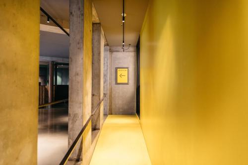 a hallway with yellow walls and a yellow wall at Exeter Hotel in Reykjavík