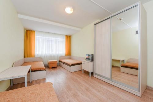 a room with two beds and a sliding glass door at KTU Rest House Politechnika in Palanga