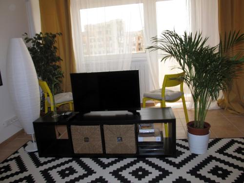a living room with a tv on a table at My Little Studio in Bucharest