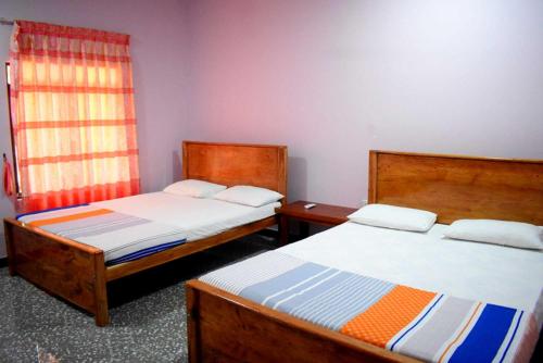 Postel nebo postele na pokoji v ubytování Yaswi Guest House