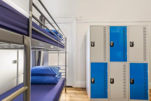 a room with two bunk beds with blue pillows at Sydney Backpackers in Sydney