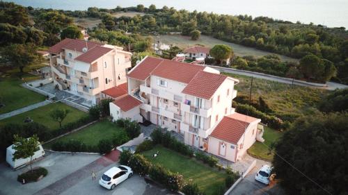 an aerial view of a large house with a car parked in a parking lot at Panorama Fanari studios and apartments in Argostoli