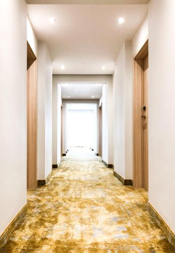 an empty corridor of an office building with a painting on the floor at The Sun by Lubicz in Ustka