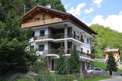 a large white building with balconies and trees at Casa Herin-La borna du Tésòn - CIR VDA - VALTOURNENCHE - n 0254 in Valtournenche