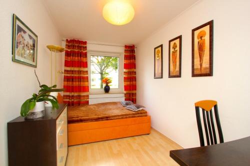 a bedroom with a bed in a room with a window at Private Rooms Laatzen in Hannover