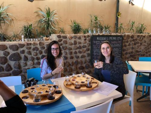 two women sitting at a table with glasses of wine at Lanseria Country Estate in Lanseria