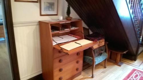 a desk in a room with a table and a drawer at The Townhouse in Elphin