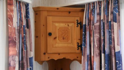 a wooden cabinet in a room with curtains at Marktgasse 9 in Appenzell