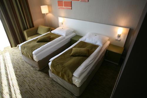 Postel nebo postele na pokoji v ubytování Hotel EMPIRE