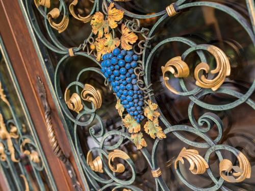 a bunch of grapes on a metal fence at Hotel Landhaus Sonnenhof in Todtnau