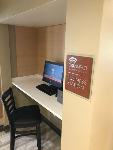 a desk with a computer and a chair on it at AmericInn by Wyndham Jefferson in Jefferson