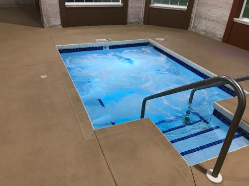 a lap swimming pool with stairs in a building at AmericInn by Wyndham Jefferson in Jefferson