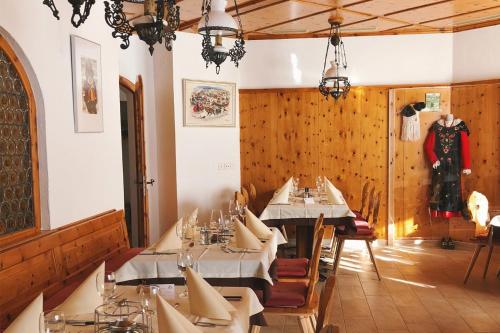 a dining room with tables in a restaurant at Catrina Hotel in Disentis