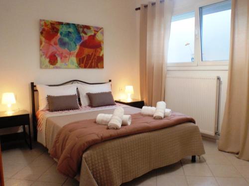 a bedroom with a large bed with towels on it at Summerhouse Anastasia in Alexandroupoli