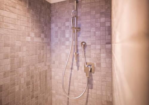 a shower with a hose in a bathroom at porto canale b & b in Cesenatico