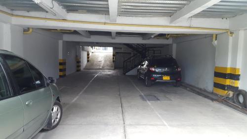 a parking garage with two cars parked in it at Hotel Aussie koala in Armenia