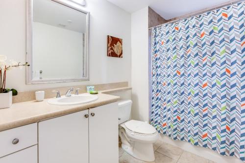 a bathroom with a toilet and a shower curtain at Dadeland Towers by Miami Vacations in South Miami