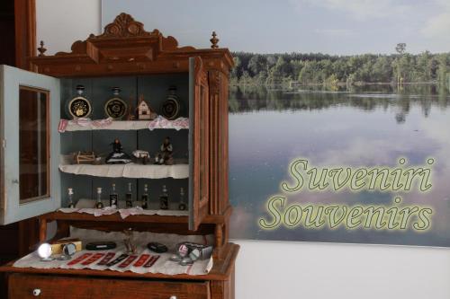 a display cabinet with a picture of a lake at Hotel Lug in Osijek