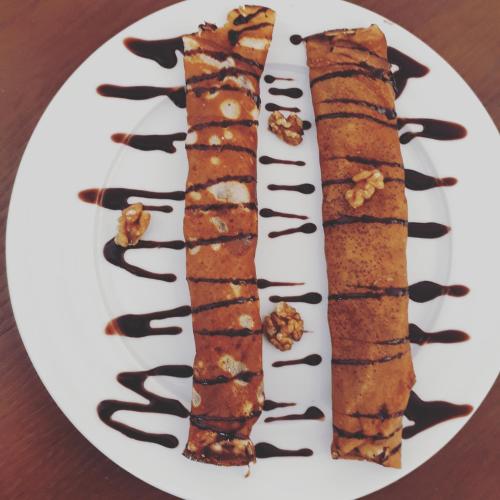 two sushi rolls on a white plate on a table at Apartments Kuce Lekovica Beach & snack bar- Bistro in Bar