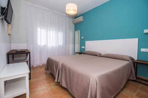 Postel nebo postele na pokoji v ubytování Hostal Las Cumbres