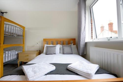 a bedroom with a bed with two towels on it at Southsea Rocks Hotel in Portsmouth