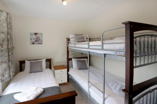 two bunk beds in a small room with two beds at Southsea Rocks Hotel in Portsmouth