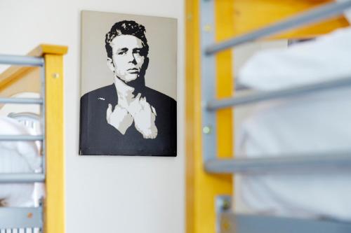 a picture of a man hanging on a wall at Southsea Rocks Hotel in Portsmouth