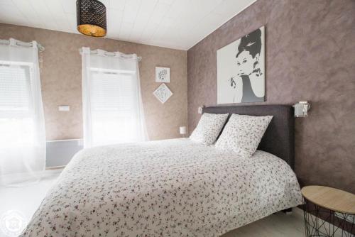 a bedroom with a large bed with a white bedspread at Gite de la plaine in Saint-Ignat