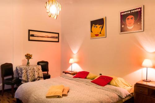 a bedroom with a bed and two pictures on the wall at Casa Nuestra Peru in Lima