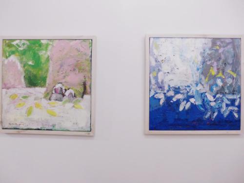 two paintings hanging on a white wall at Picasso Guesthouse in Mokpo