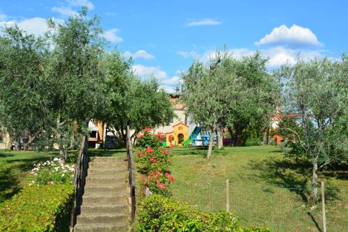 a garden with stairs and flowers in front of a house at Residenza Corte Casara in Lazise