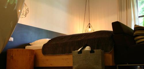 a bedroom with a bed and a shopping bag at MONTAFONLodge in Gaschurn