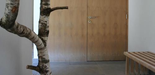 a tree in front of a wooden door at MONTAFONLodge in Gaschurn