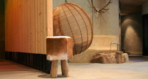 a wooden chair in a room with a fan at MONTAFONLodge in Gaschurn