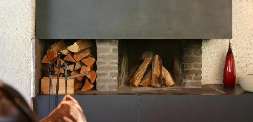 a pile of wood in a fire place at MONTAFONLodge in Gaschurn