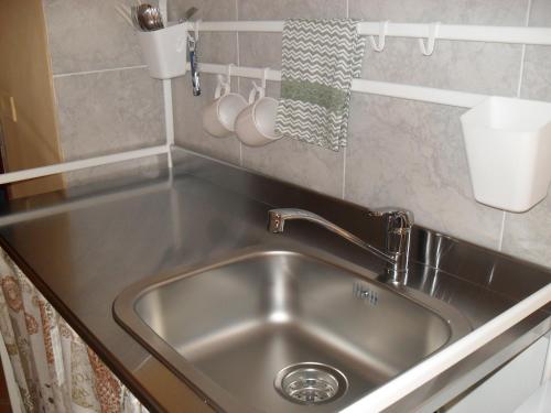 a stainless steel sink in a small kitchen at Casa Del Padrino in Ispica